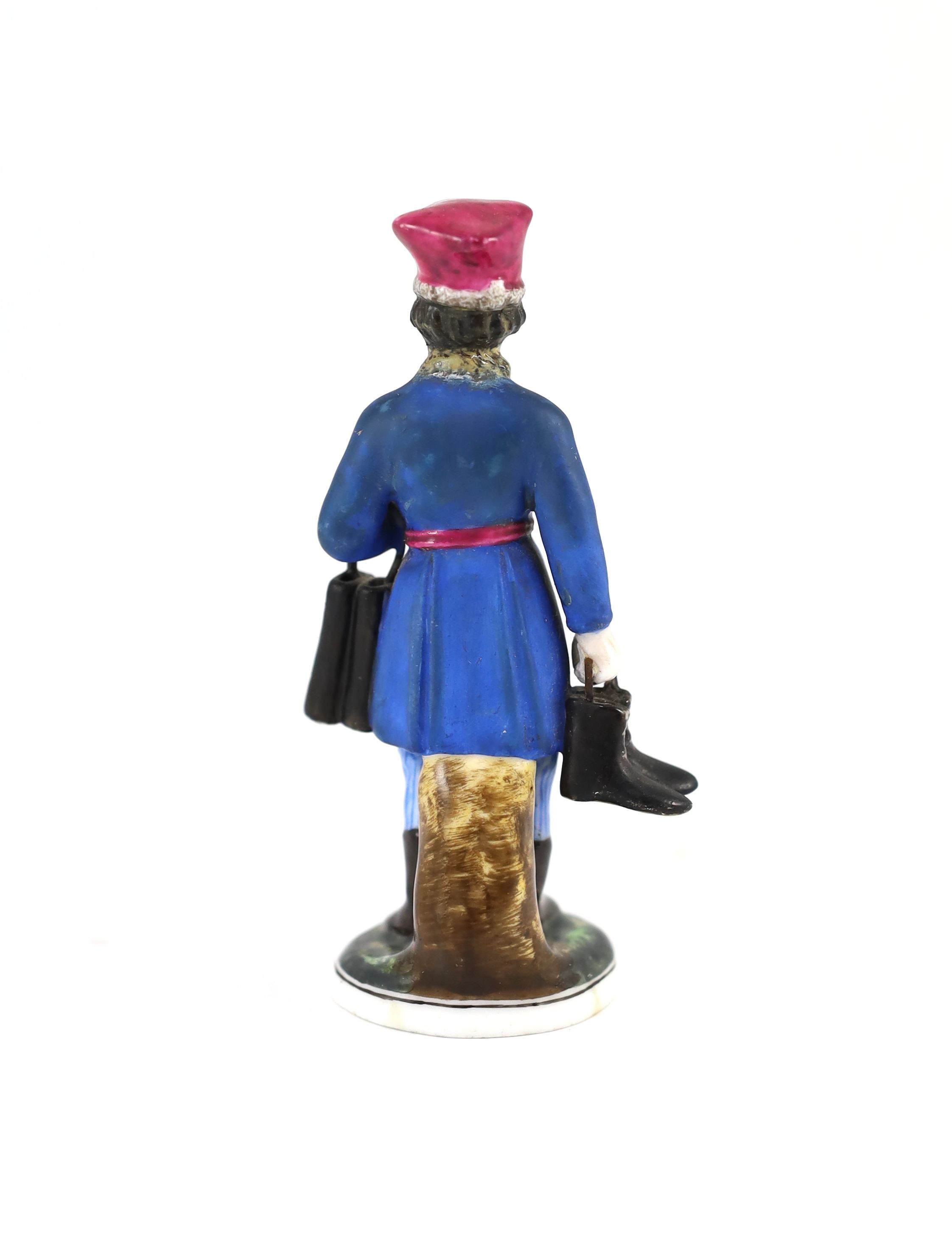 A Russian porcelain figure of a boot seller, Gardner Manufactory, Verbilki, c.1825, 10.8cm high, restoration